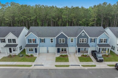 Multi unit property with driveway, a garage, a shingled roof, and a forest view