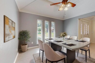 Dining room featuring ceiling fan, ornamental mold