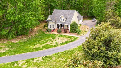 View of front of property with asphalt driveway, c