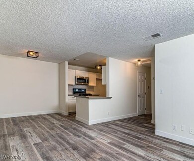 Kitchen featuring stainless steel microwave, range