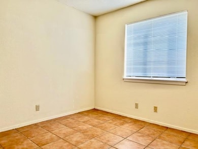 Spare room featuring baseboards and light tile pa