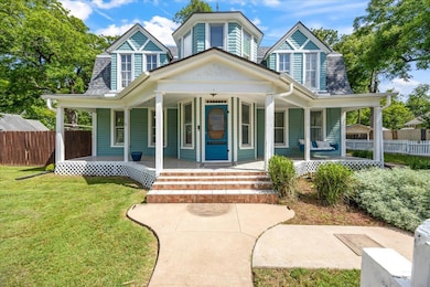 View of front of house featuring a porch and a sh