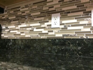 tiled black splash in kitchen
