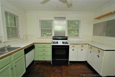 Kitchen is spacious, to the right are the original