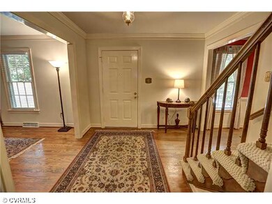 Foyer - Foyer view with hardwood floor, crown mold