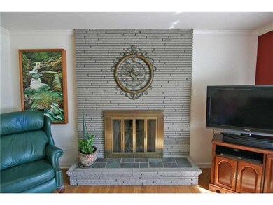 Living Room. The raised hearth fireplace features 