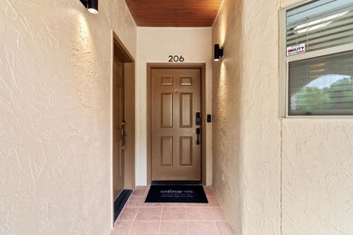 Property entrance featuring stucco siding
