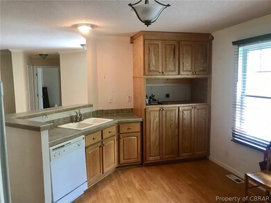 Another view of the kitchen with more cabinets
