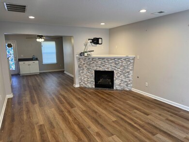 Unfurnished living room featuring a fireplace, cei