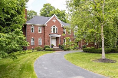 Front door with covered porch, circular driveway i