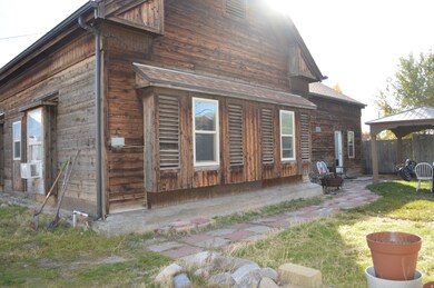 Rear view of house with a gazebo, a patio, and cooling unit