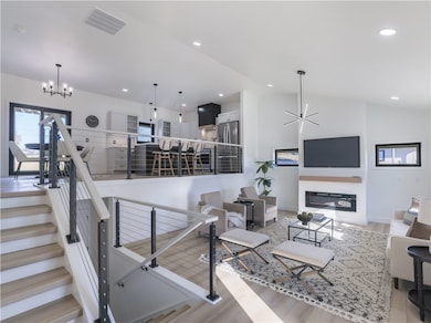 The expansive openness comes from vaulted ceilings & wire railings vs a drywall knee wall.