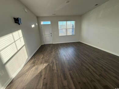 Interior space with dark hardwood / wood-style flo