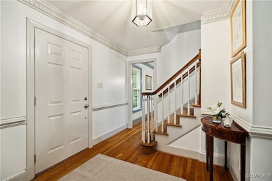 Entrance foyer featuring wood finished floors, sta