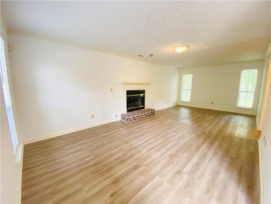 Unfurnished living room featuring light wood-style