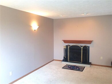 Spacious living room with neutral tones and firepl