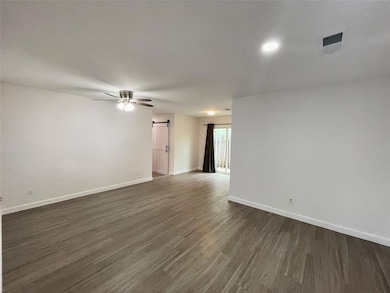 Spare room featuring a barn door, dark wood-style