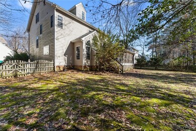 View of side of home with a yard and a sunroom