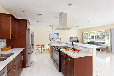 Kitchen offers wood cabinets, a breakfast bar and