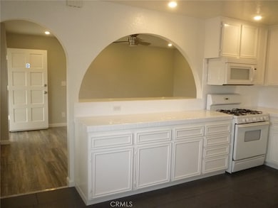 This kitchen is large with plenty of storage space.  The front door is to the left and the kitchen opens to the living room.