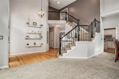 Step inside the soaring 2-story hardwood foyer and