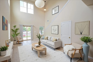 Living area featuring a high ceiling and light wo