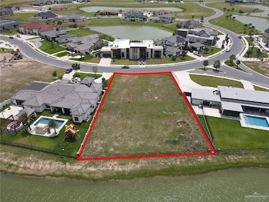 Aerial perspective of suburban area with property parcel outlined and a large body of water