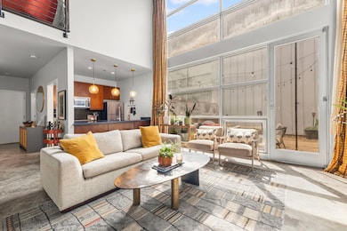 Living room featuring a towering ceiling and concrete flooring