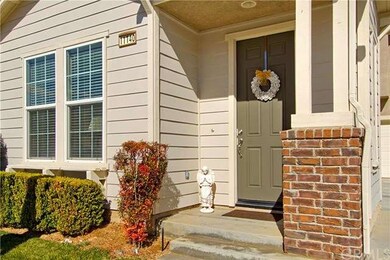 Inviting Front Porch entry adorned with brick acce