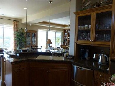 Kitchen sink faces breakfast bar with designer lig