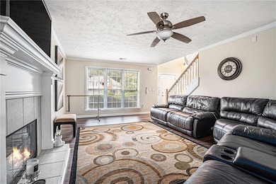Living room featuring stairs, crown molding, a fir