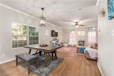 Dining space with wood-type flooring, ornamental m