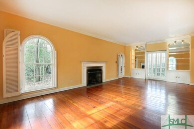 Formal Living Room has fireplace and pine floors. 