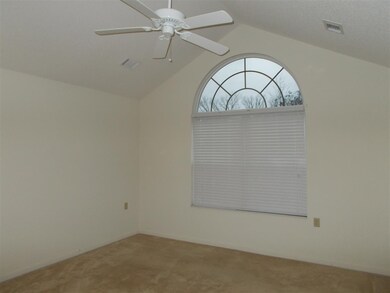 Bright master bedroom with vault ceilings.