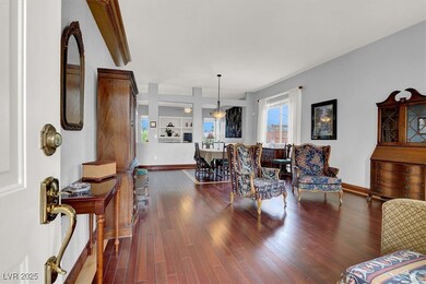Living area featuring baseboards and dark wood-typ