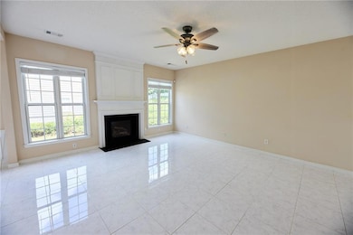Unfurnished living room with ceiling fan, baseboar