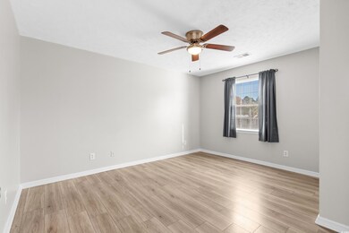 Unfurnished room with ceiling fan, light hardwood 