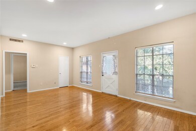 Living room with recessed lighting and light wood-type flooring