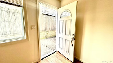 Entryway featuring wood finished floors and baseboards
