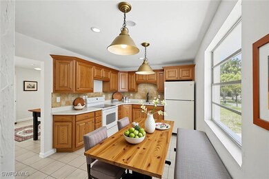 Kitchen featuring white appliances, light tile pat