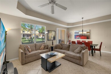 Living room featuring ceiling fan with notable cha