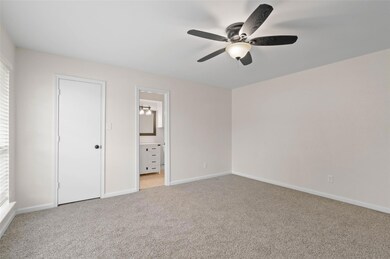 Unfurnished bedroom with light colored carpet, a c