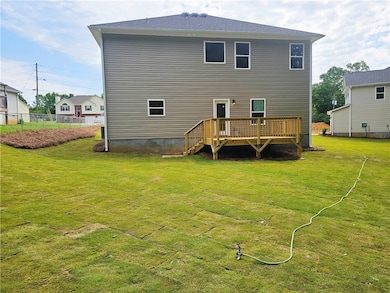 Back of house with a deck