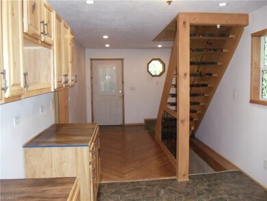 Front entry view with decor that blends with natur