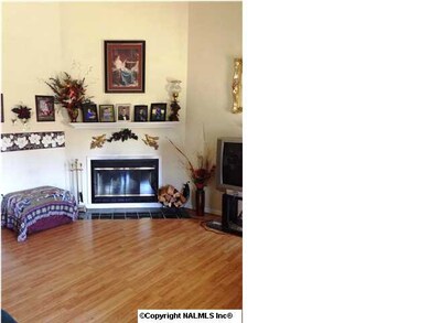 Spacious living room with soaring ceiling and corner fireplace