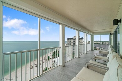 Sunroom / solarium featuring view of water and beach
