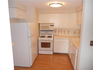 Stylish Pergo flooring in kitchen, dining room and