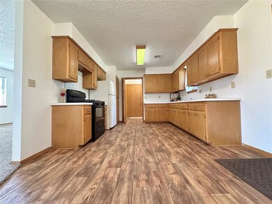Kitchen with hardwood / wood-style flooring, a tex
