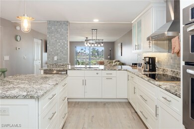 Kitchen featuring decorative light fixtures, stain