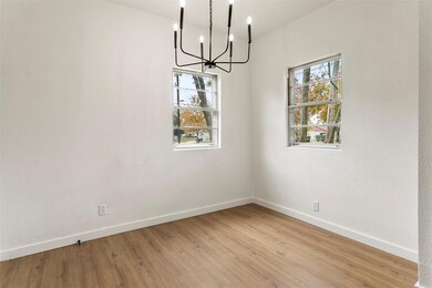 Unfurnished dining area featuring light hardwood / wood-style floors, a wealth of natural light, and a notable chandelier